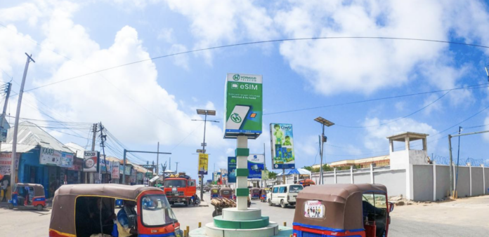 A banner displays Hormuud Telecom on a street in Mogadishu.